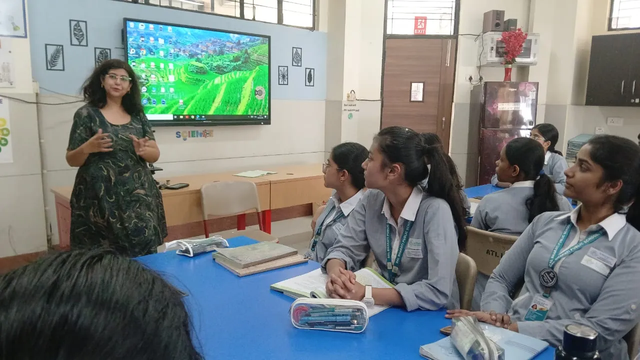 Dr Tarang Jain Arora teaching a group in a school laboratory.
